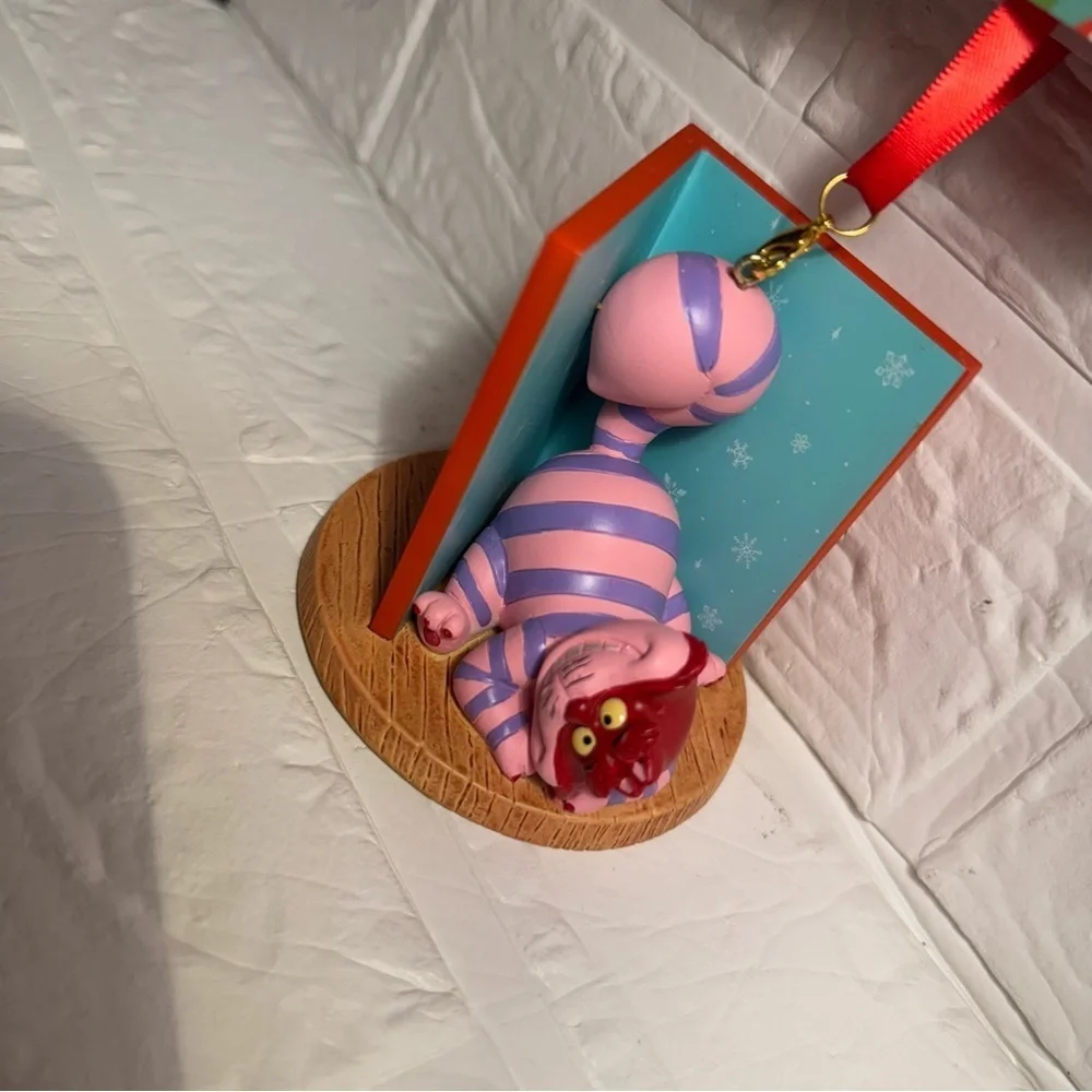New Disney Cheshire Cat Christmas Ornament in Book Red and Purple